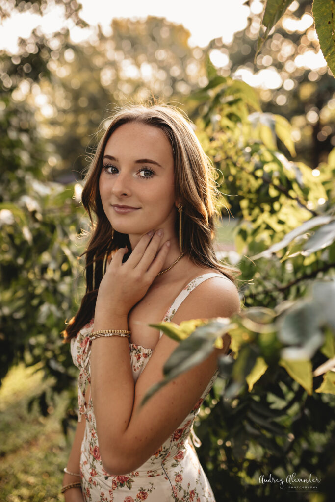 Senior girl posing greenry