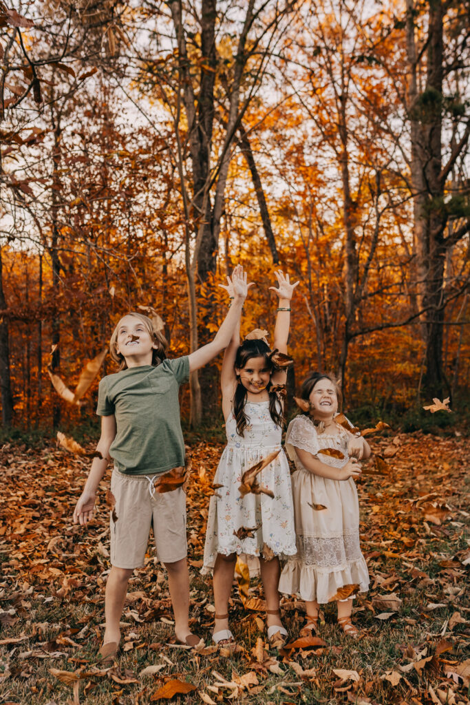 Kids having fun in a fall family photo with Audrey Alexander Photography