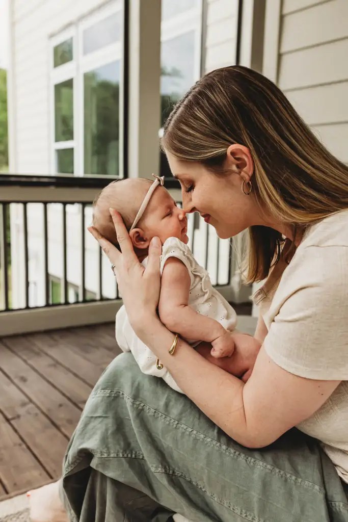 Mom and newborn baby cuddling at newborn session in Roswell, GA by Marietta Photographer