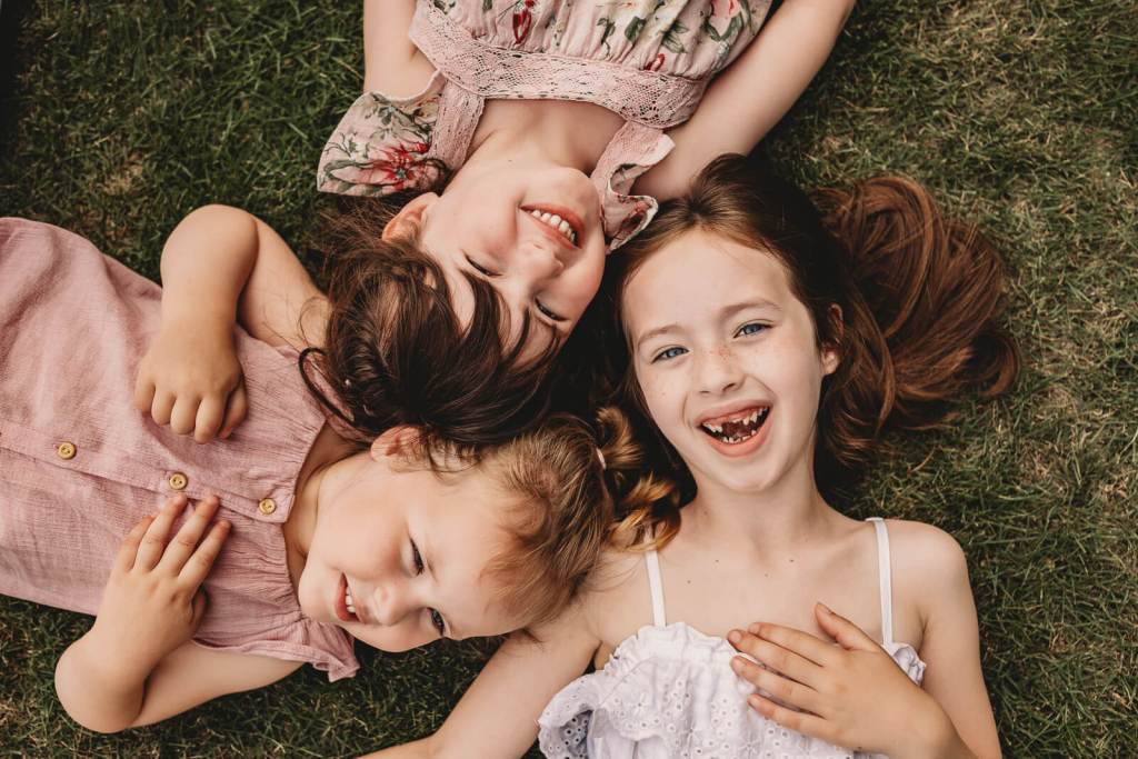 Siblings laughing at a family photoshoot in Milton Ga
