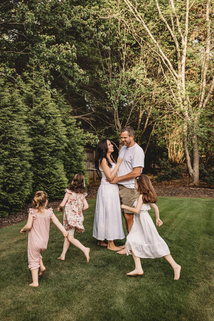Family laughing and playing while being photographed