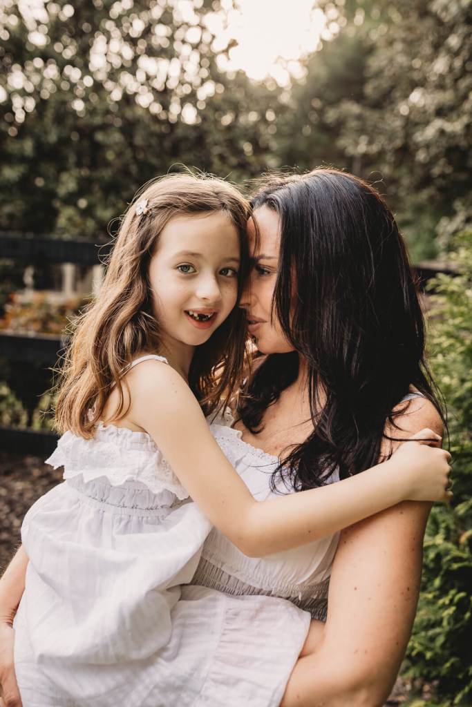 Mother and child hugging in backyard photo session in Milton Ga