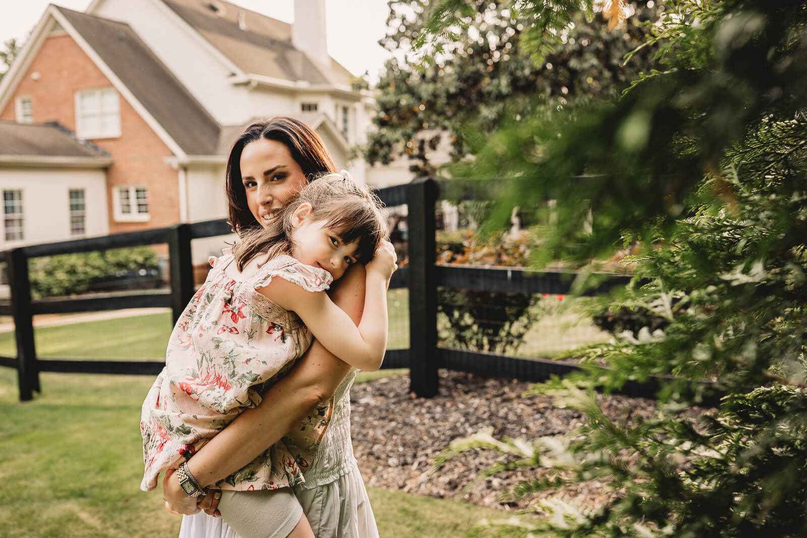 Mother and child hugging in backyard photo session in Milton Ga