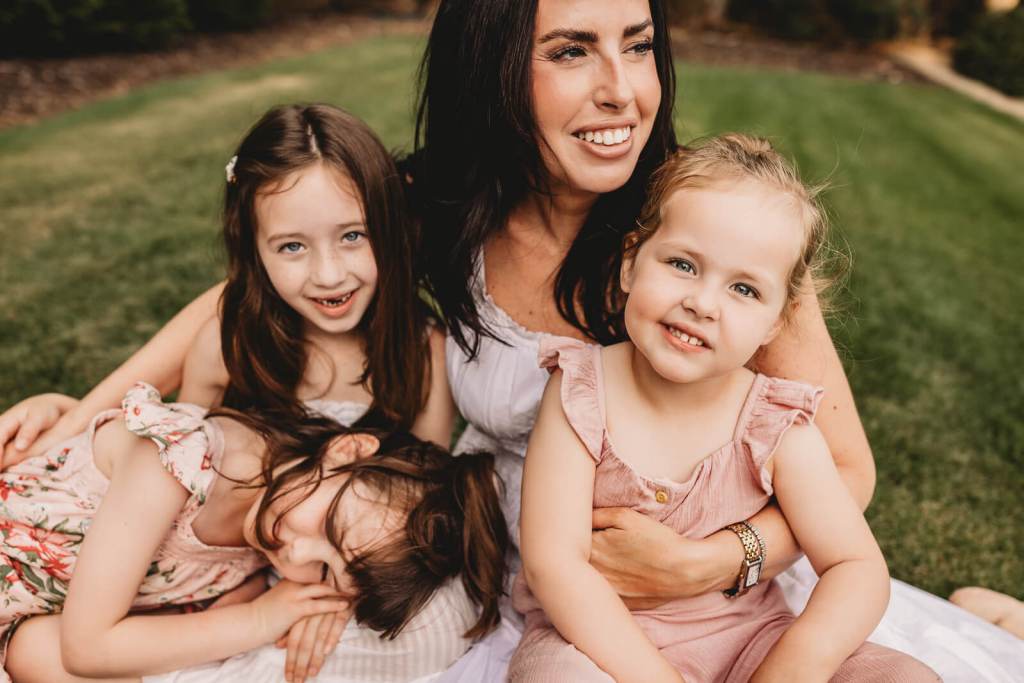 Mother and children laughing together at a photography session