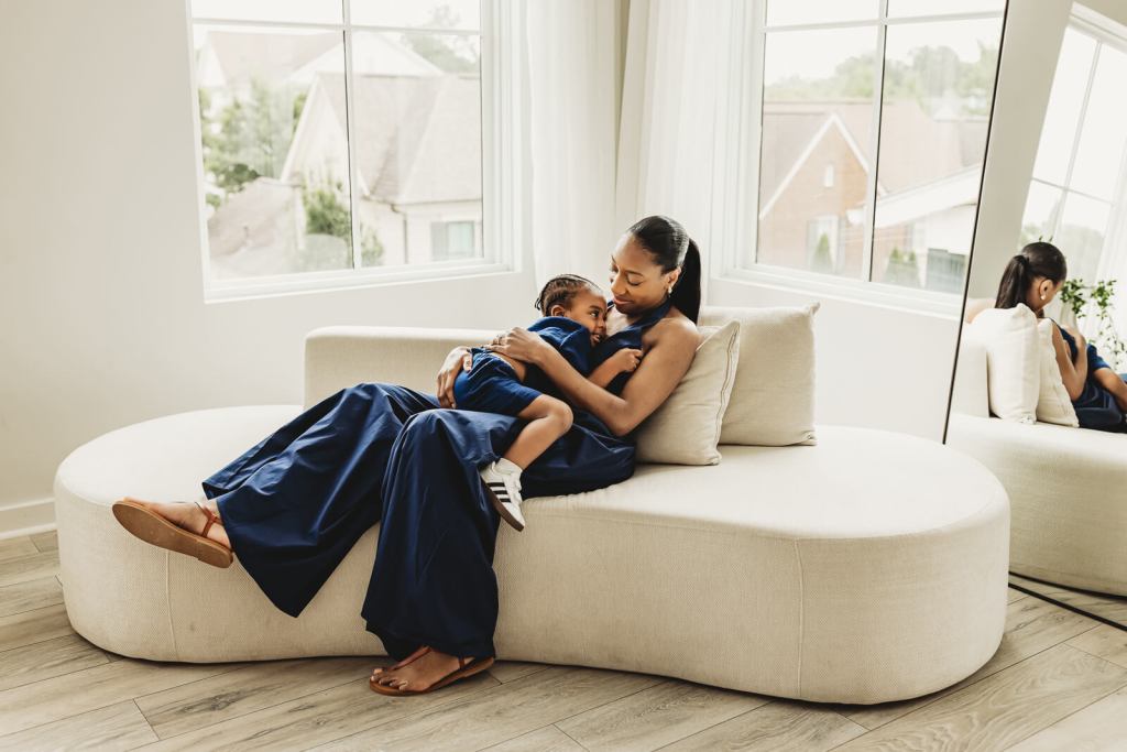 Mother and son smiling and cuddling in a studio photo session