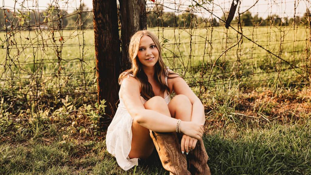 Marietta Senior portrait by rustic fence in Georgia