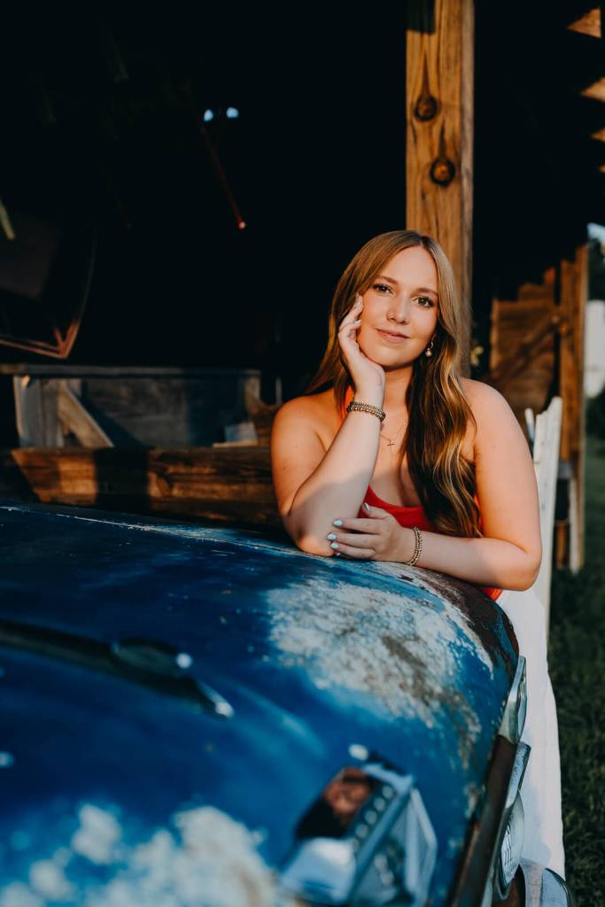 Senior girl on vintage car during photo session in Marietta