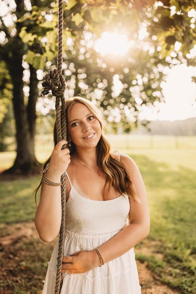 Senior girl on vintage swing during photo session