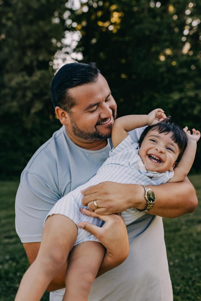 Dad and toddler playing at family photo shoot