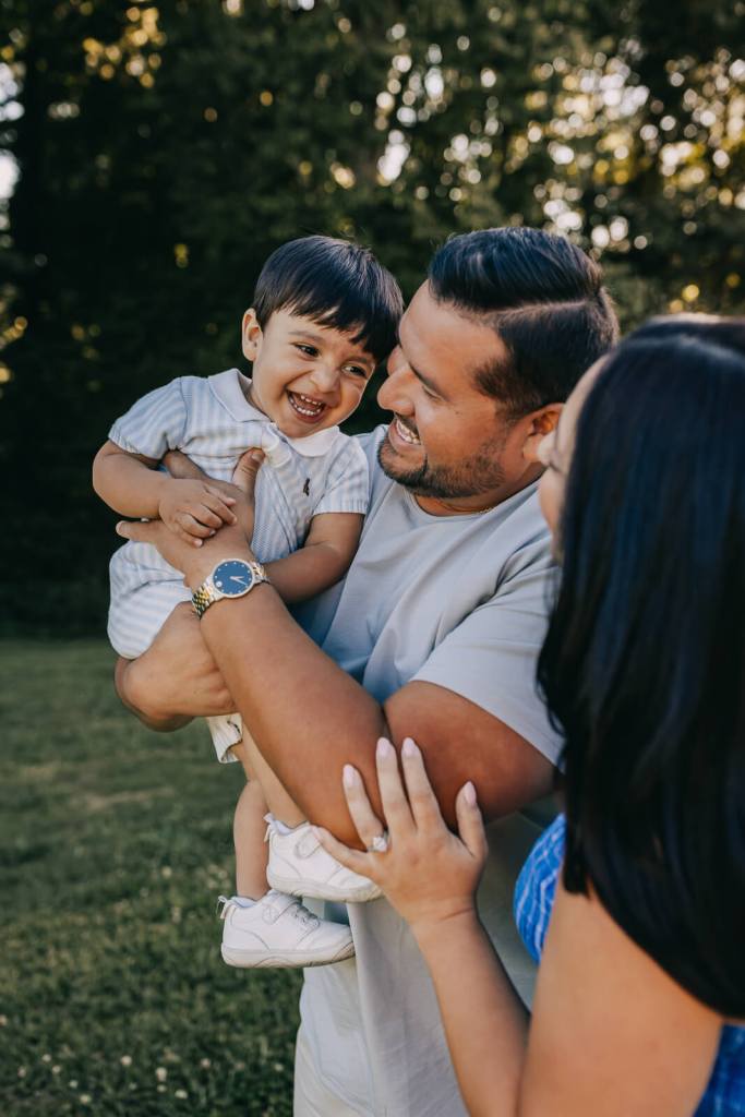child laughing at family photo session with parents in Roswell GA